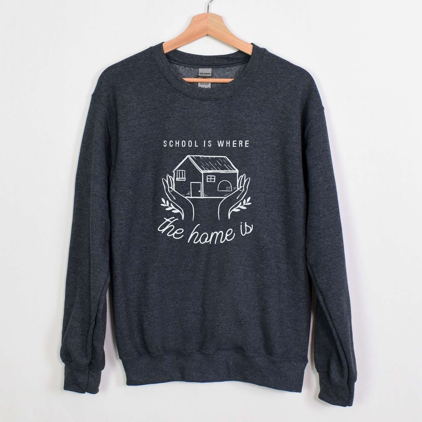 Womens Crewneck Sweatshirt Wolfe Paw Designs Womens Crewneck SweatshirtCozy up while homeschooling your children in our School Is Where The Home Is  sweater.🤍Available in hoodie and tshirt50% cotton, 50% polyesterMedium-heavy fabricLSchool Is Where The Home Is  Womens Crewneck Sweatshirt