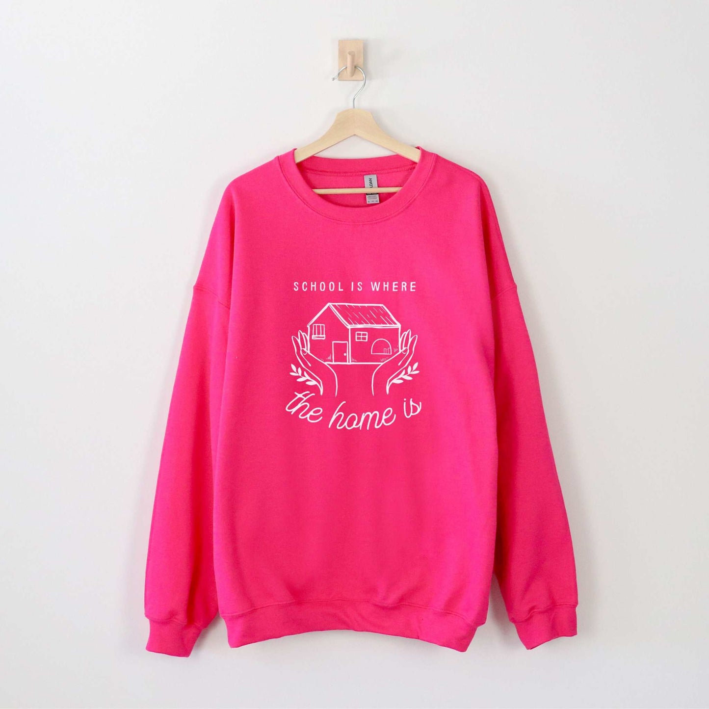 Womens Crewneck Sweatshirt Wolfe Paw Designs Womens Crewneck SweatshirtCozy up while homeschooling your children in our School Is Where The Home Is  sweater.🤍Available in hoodie and tshirt50% cotton, 50% polyesterMedium-heavy fabricLSchool Is Where The Home Is  Womens Crewneck Sweatshirt